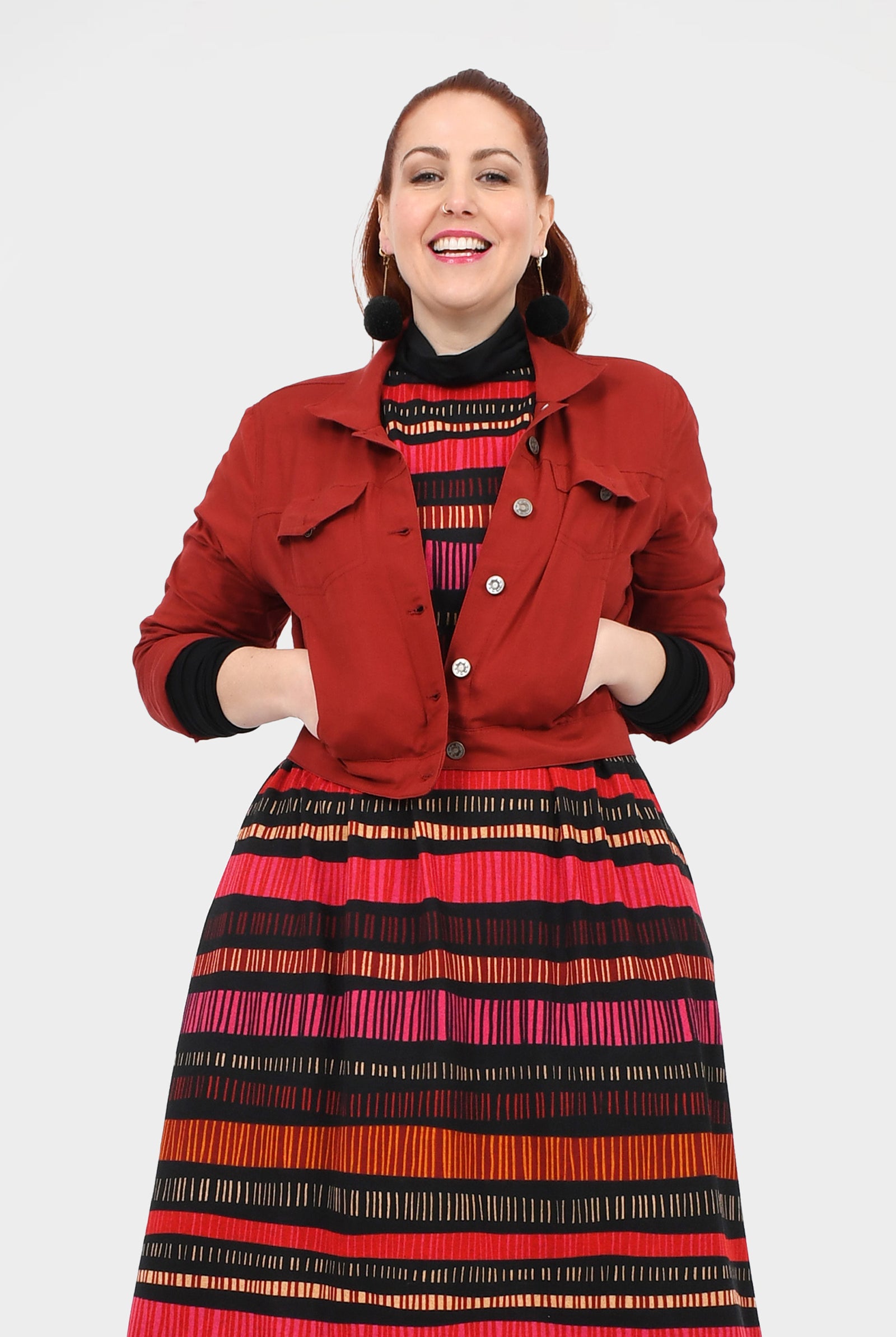 Dark red button jacket with flap pockets and pointed collar, long sleeves