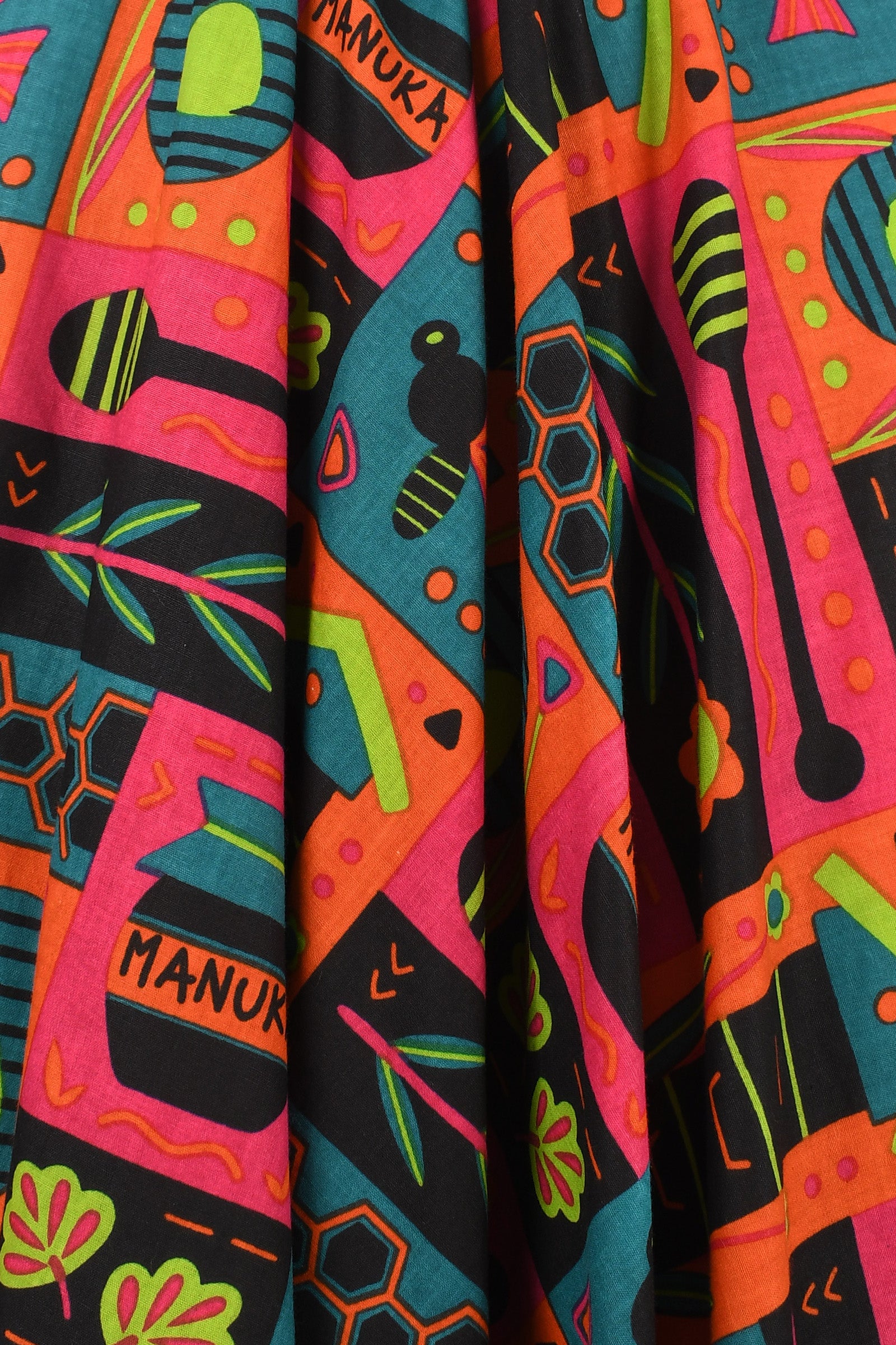 Havana pants with bold multicolor abstract print, pink, teal, orange, and green.