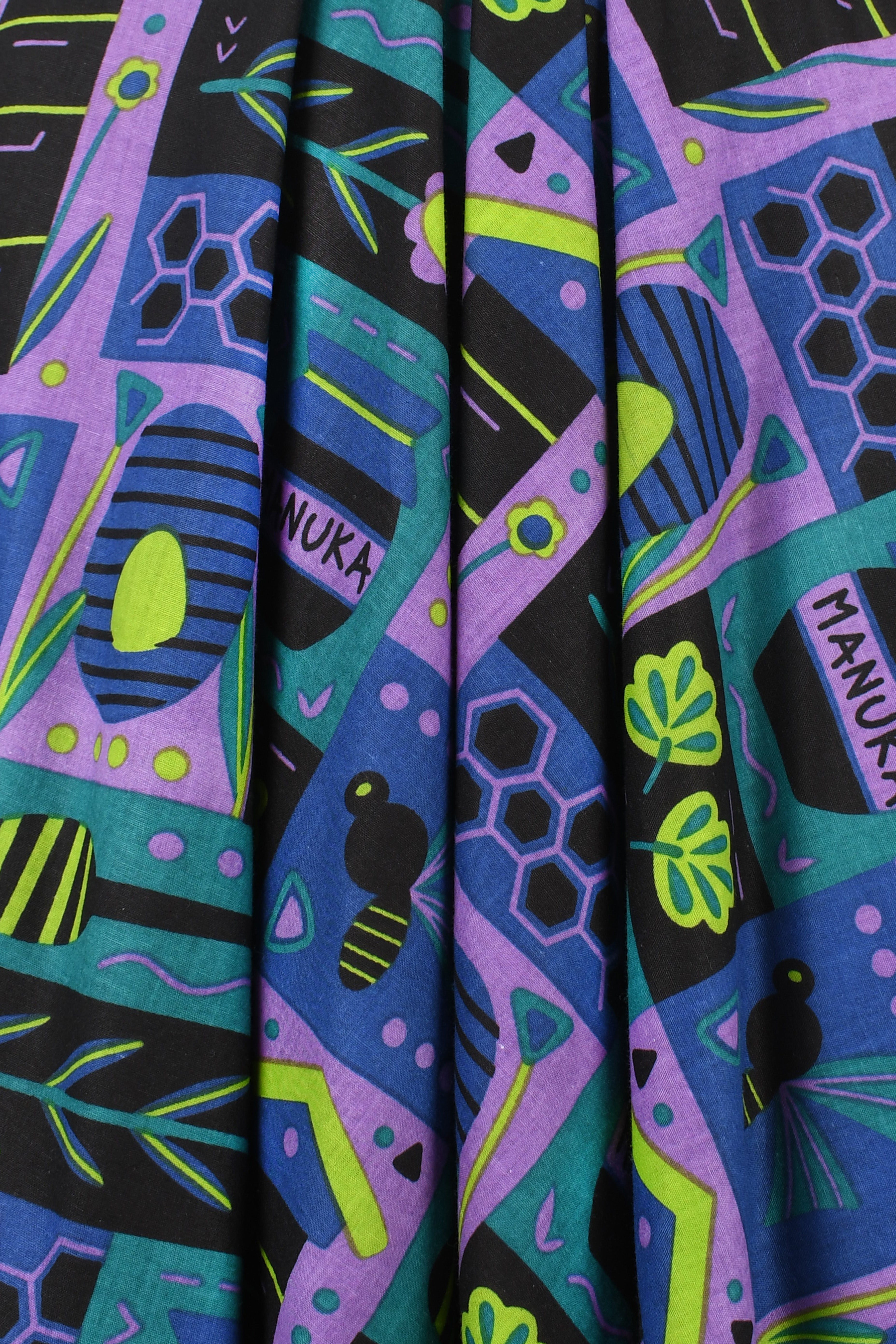 Close-up of teal, purple, and black patterned pants fabric