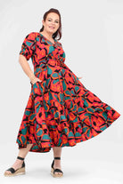 Tiered midi dress with vibrant coral and teal floral print, short puff sleeves