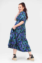 Teal-and-purple patterned midi dress, puff sleeves, button front V-neck, tiered skirt