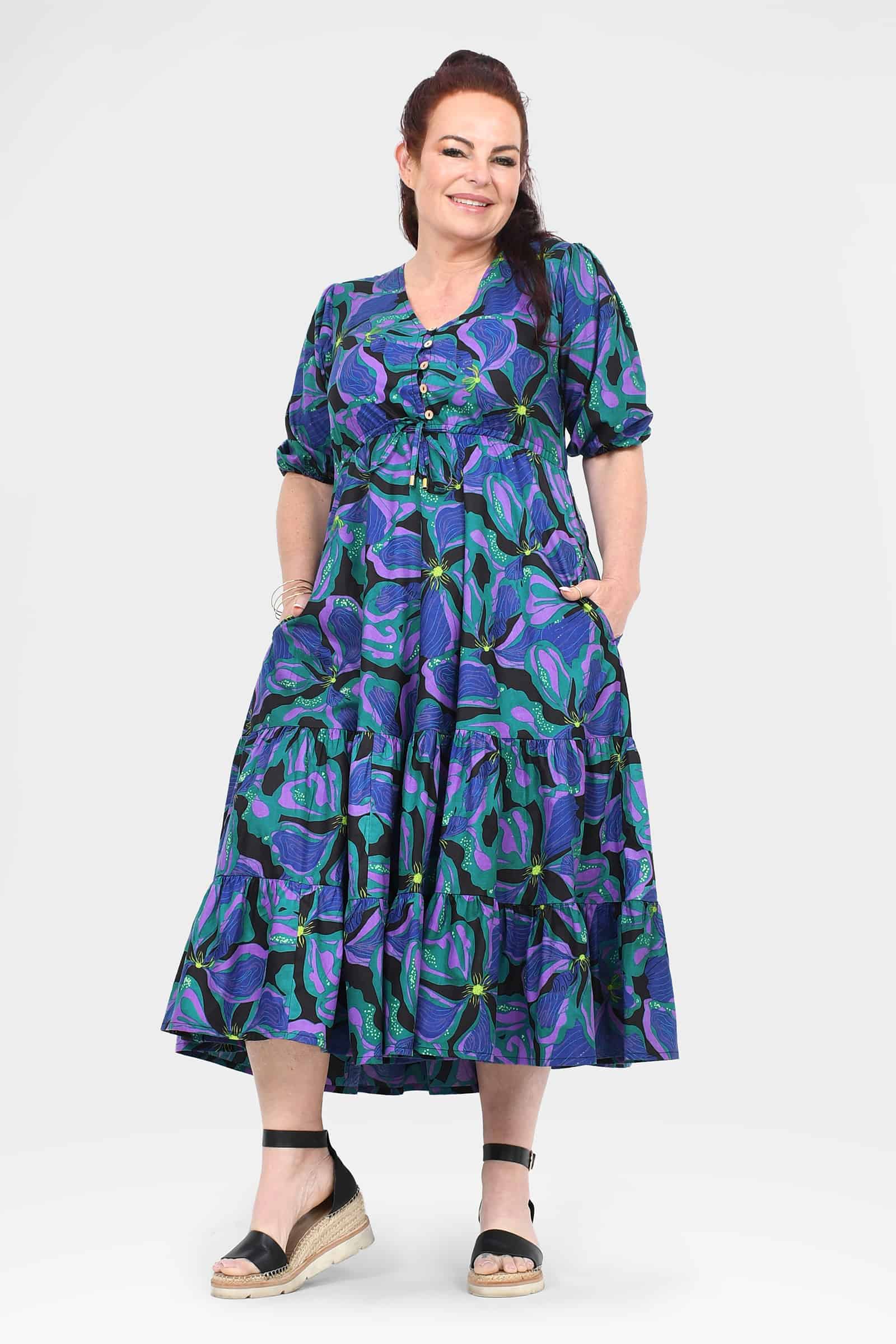 Teal midi dress with purple leaf print, gathered waist and tiered ruffle hem, button V-neck