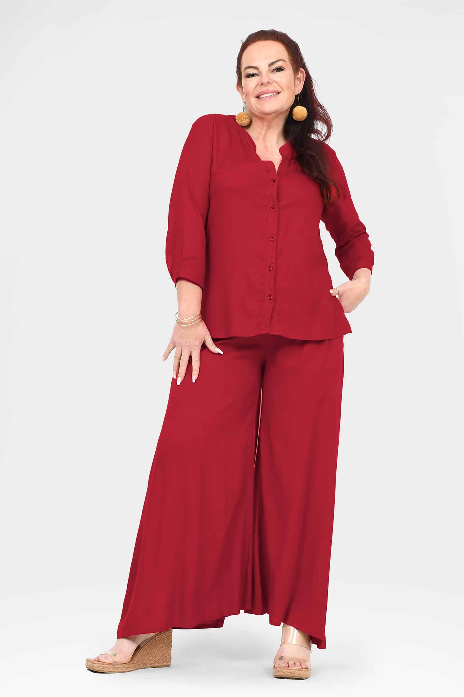 Dark red wide-leg pants with relaxed fit and draped, straight hem