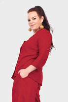 Dark red blouse top with button placket and three-quarter cuffed sleeves