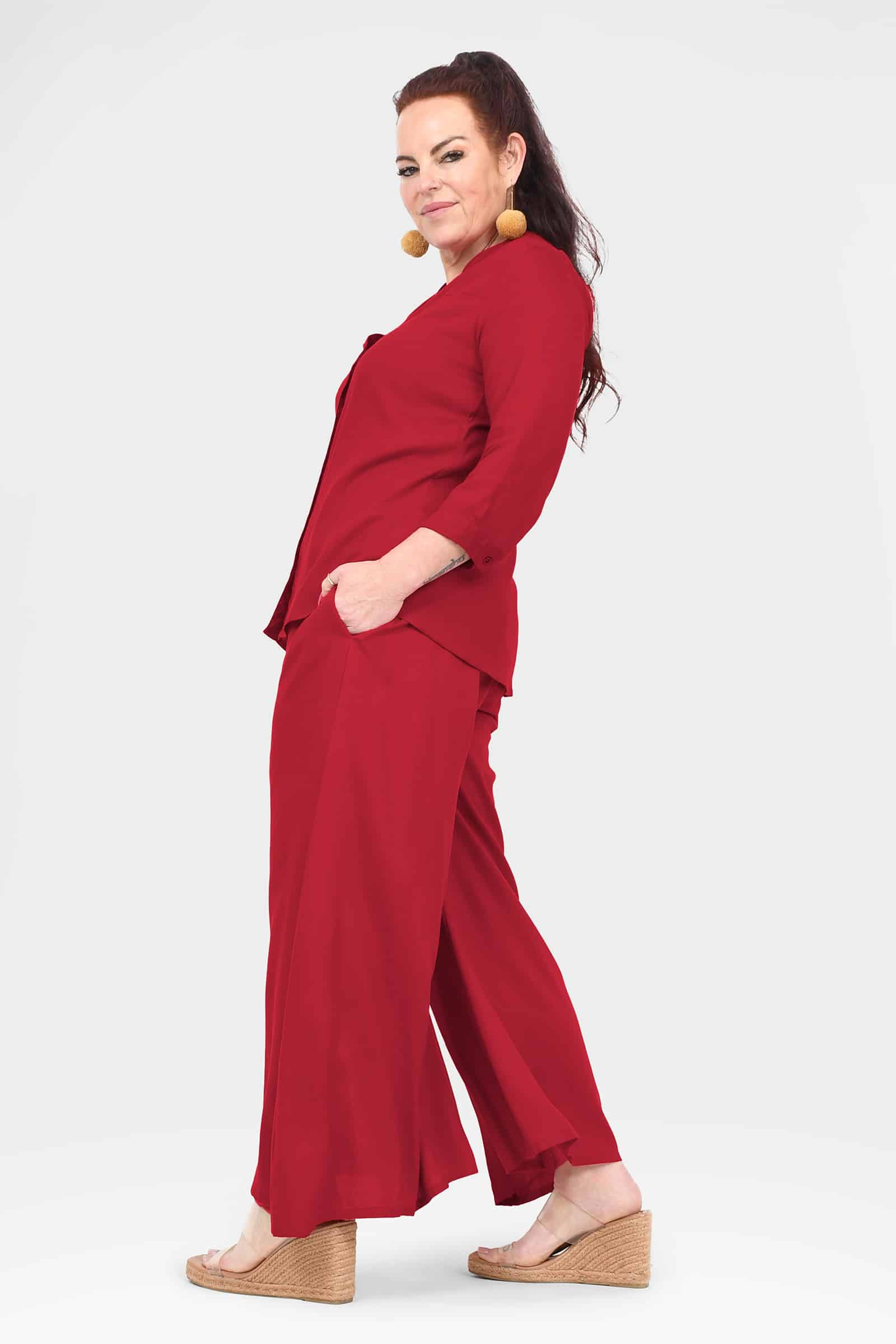 Dark red wide-leg pants with side details and ankle-length drape