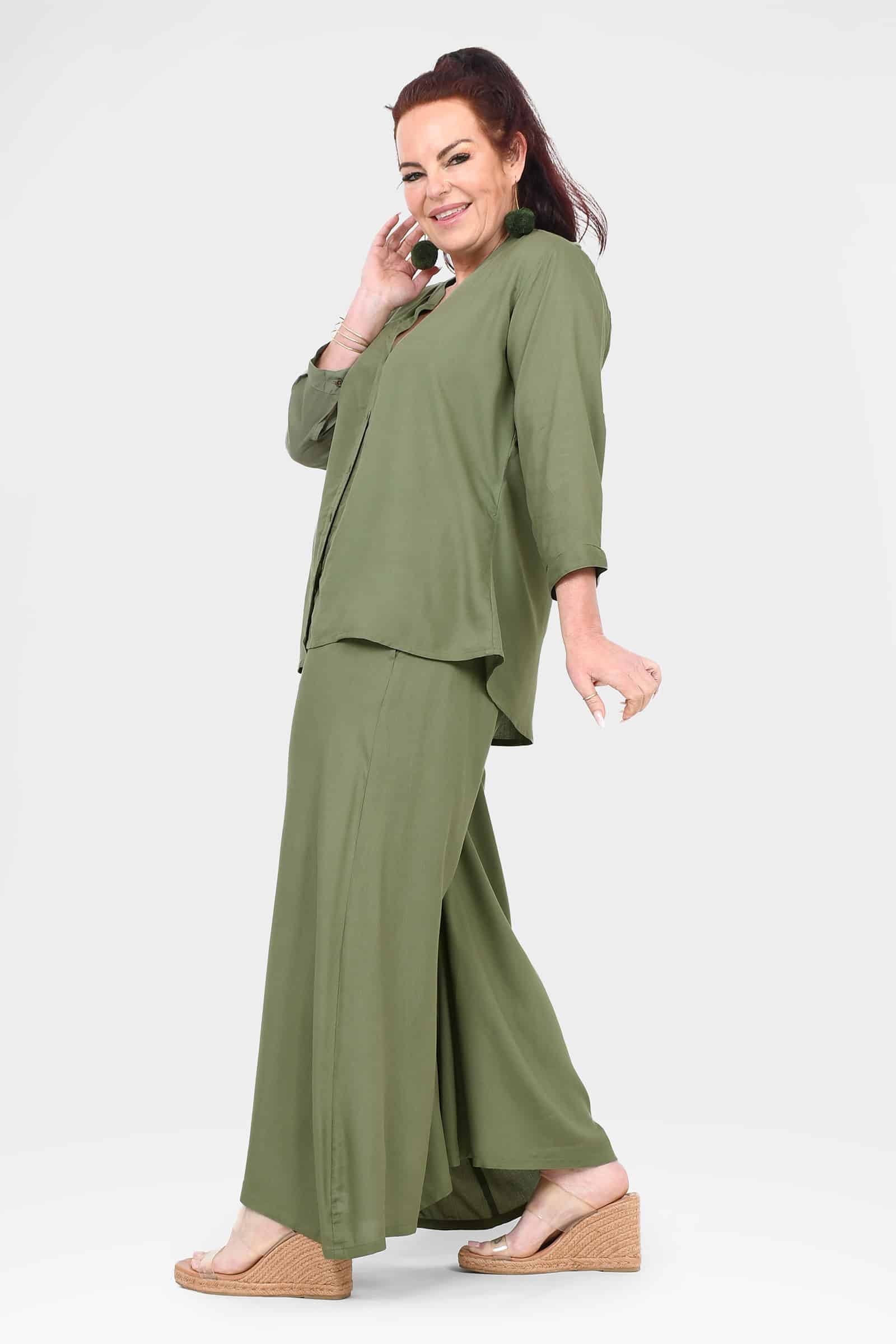 Green wide-leg pants in side view with loose fit and wide, flowing legs