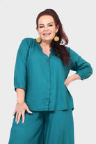 Teal button-front blouse top with three-quarter sleeves and curved hem