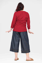 Blue denim 3/4 cropped pants, back view, with wide legs