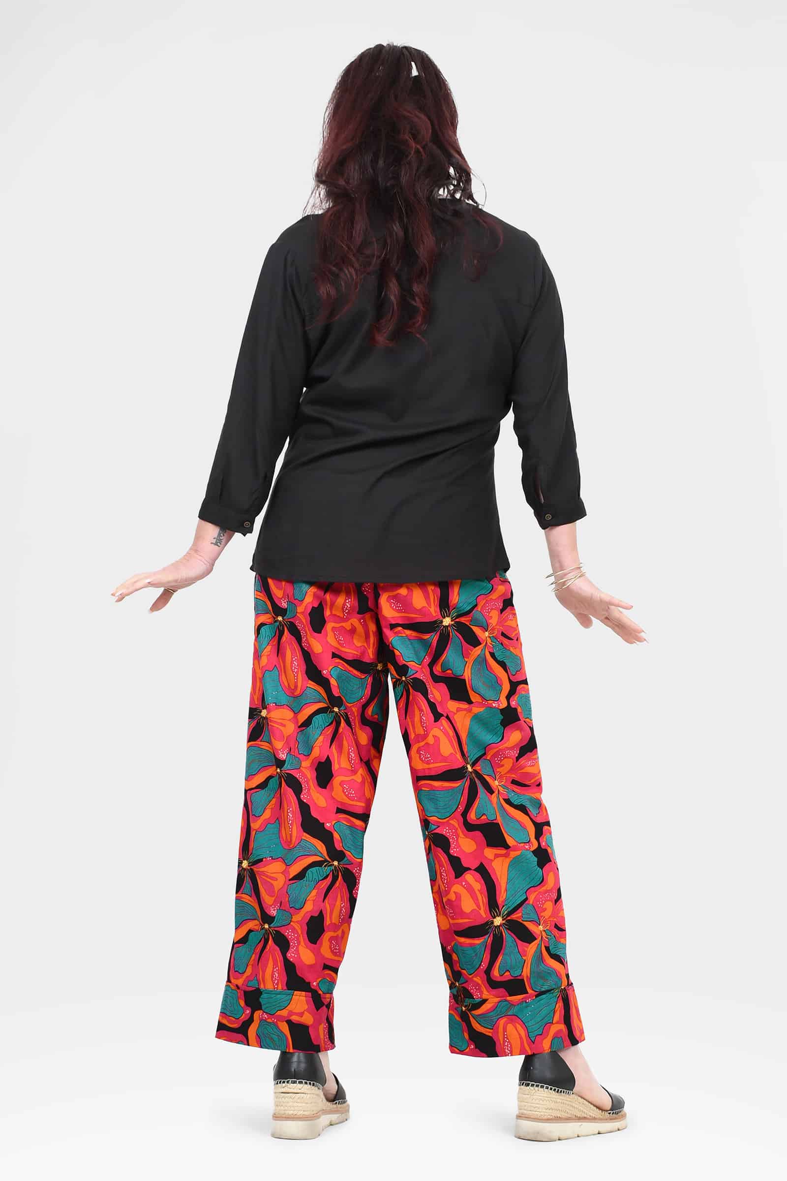 Wide-leg printed pants, abstract red and teal pattern, back view