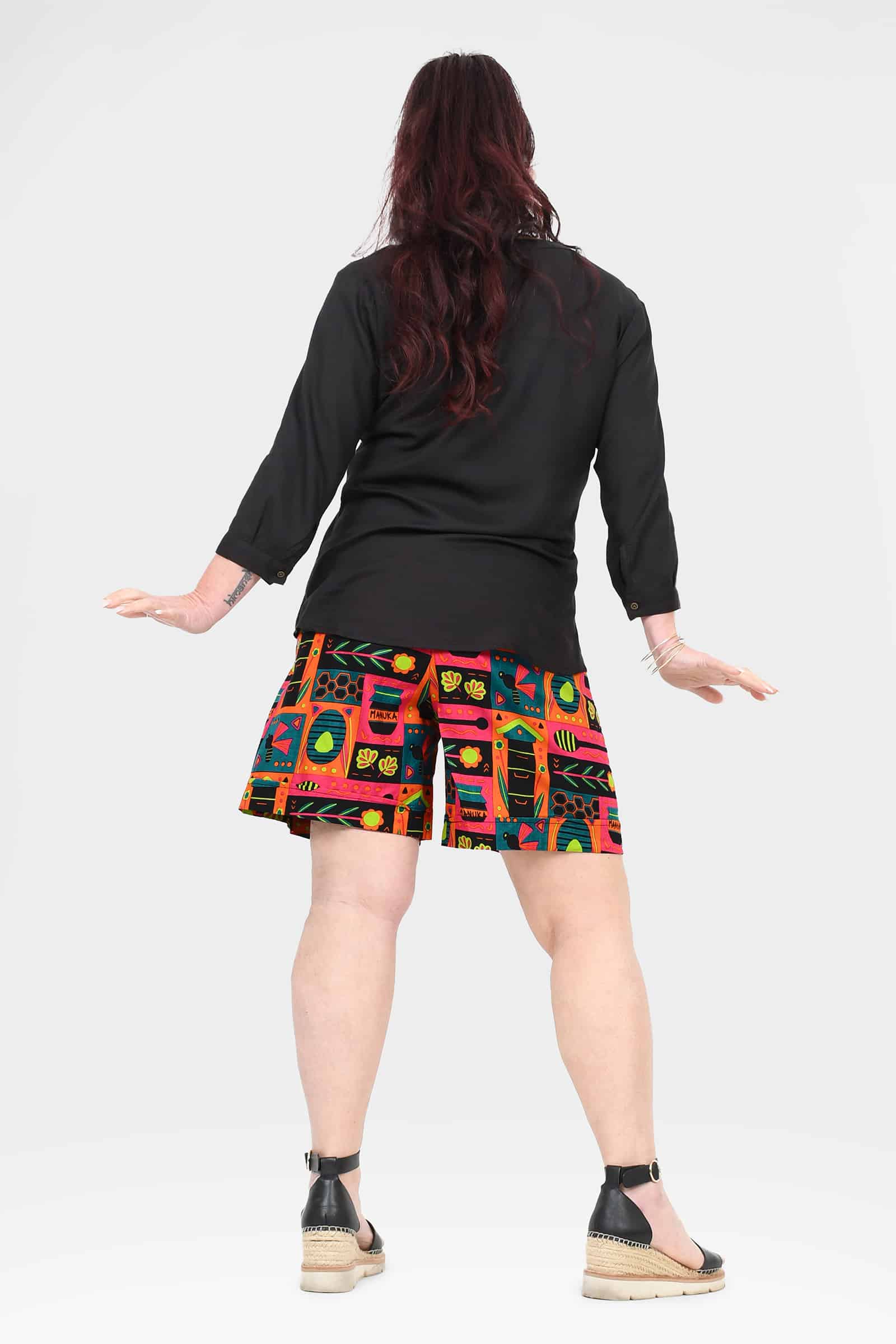 Bee-themed block print shorts, above-knee, back view