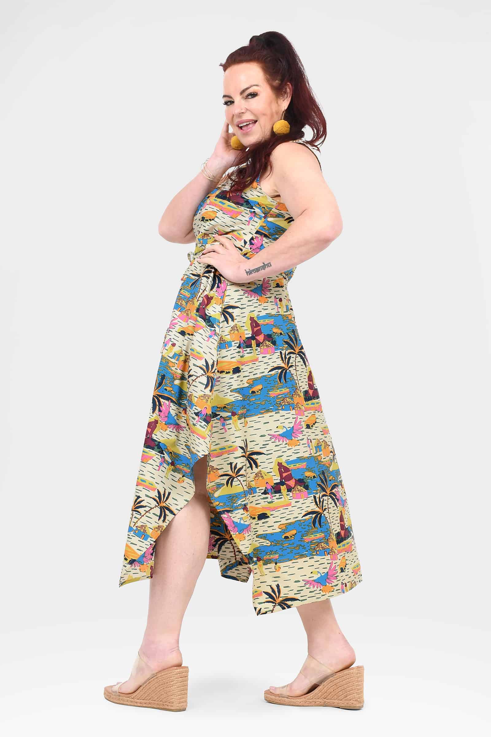 Sleeveless scoop-neck capri dress with colorful city and palm print, asym hem