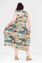 Back-view sleeveless capri dress in colorful city-and-palm print, flowing midi length