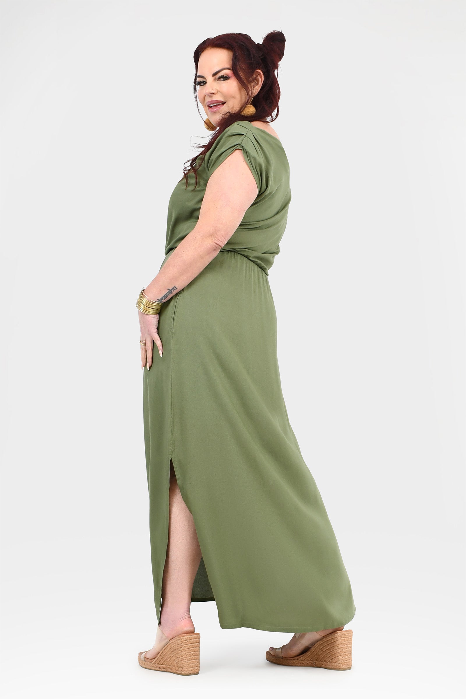 Olive green maxi dress with short sleeves, gathered waist, and leg slit