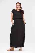 Black maxi dress with short sleeves, cowl neckline, gathered waist and side slit