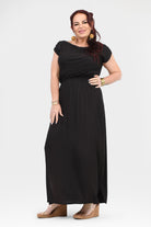 Black maxi dress with short sleeves and gathered waist, flowing skirt with side slit