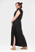 Black maxi dress side view with short sleeves, cowl neckline, and thigh-high slit