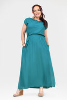 Teal maxi dress with cap sleeves, gathered waist, and long flowing skirt