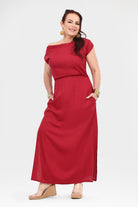 Dark red maxi dress with cap sleeves and gathered waist; walking front view