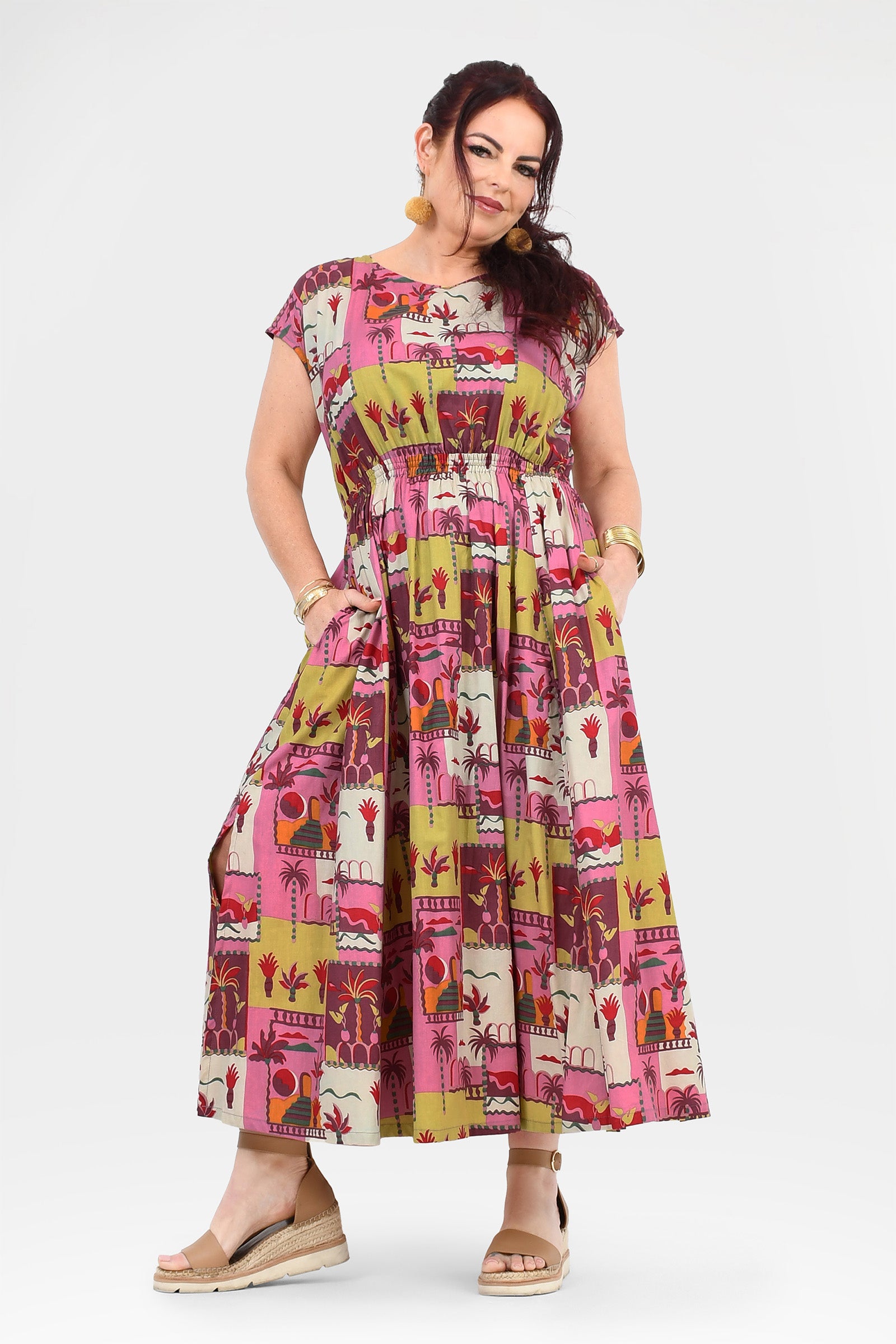 Pink long dress with colorful animal-and-cactus print, short sleeves and gathered bodice