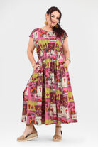 Pink long dress with colorful animal-and-cactus print, short sleeves and gathered bodice