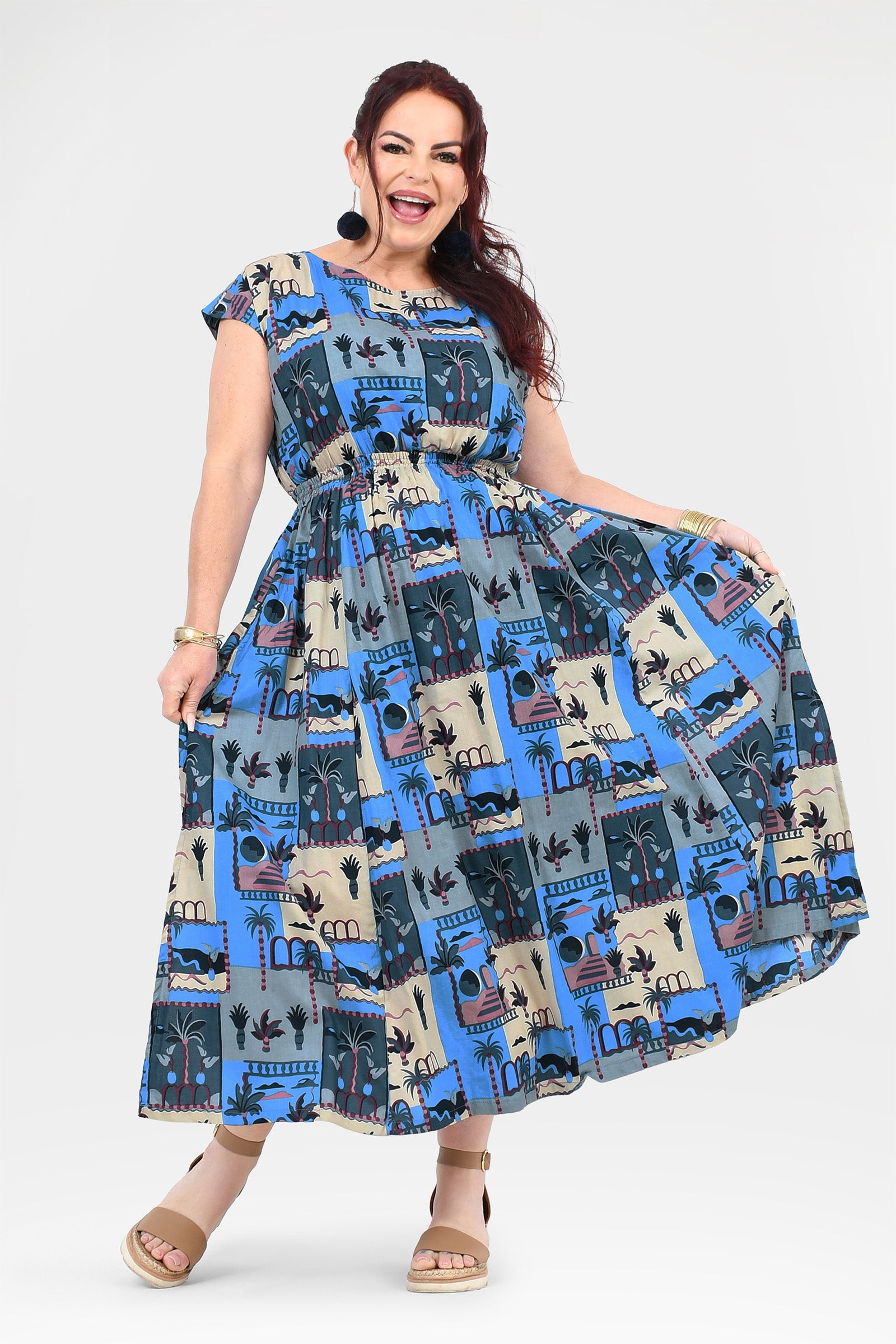 Blue and cream long dress with cap sleeves, gathered skirt, and illustrated skyline print