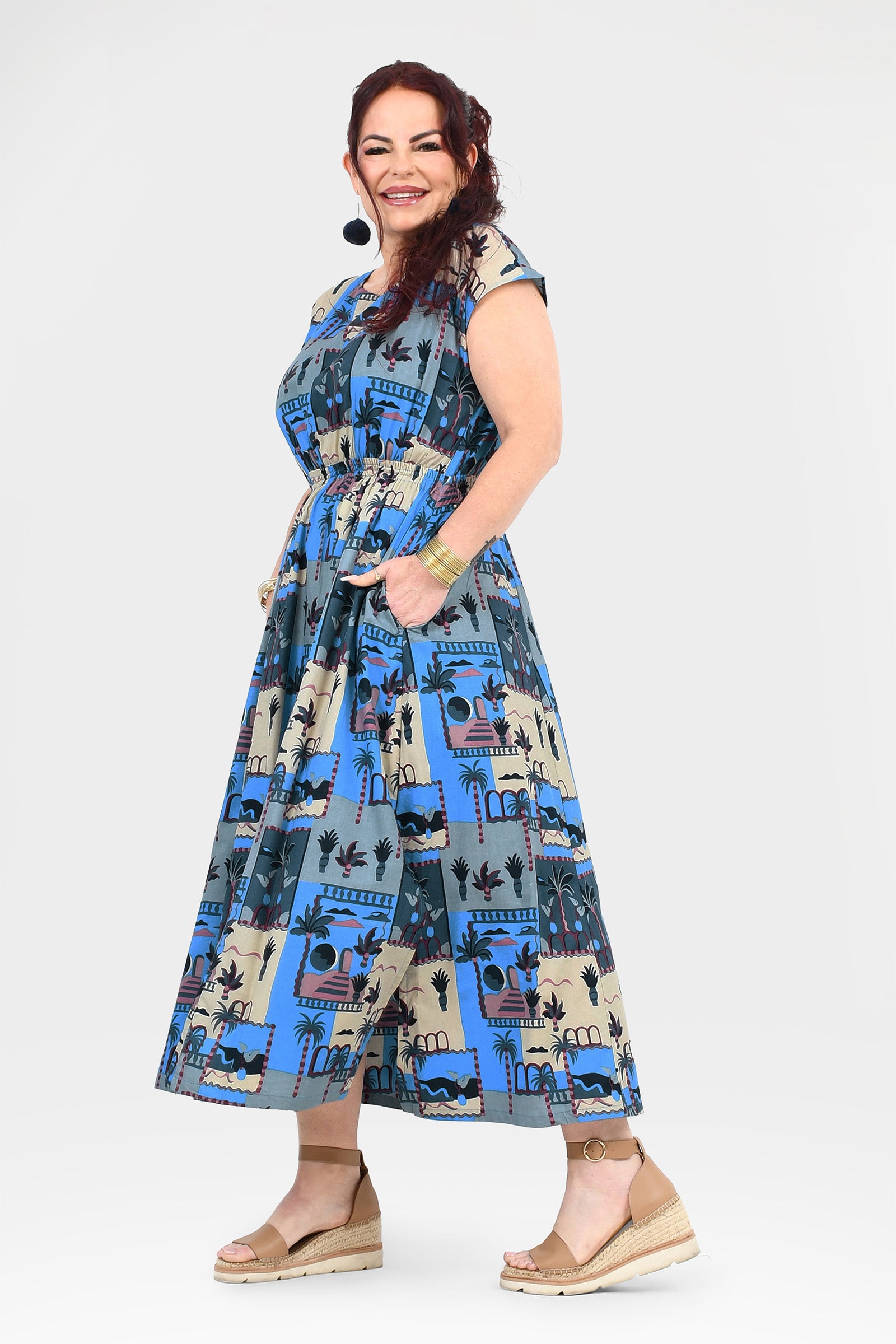 Blue-and-cream cap-sleeve long dress with full gathered skirt and colorful illustrated print
