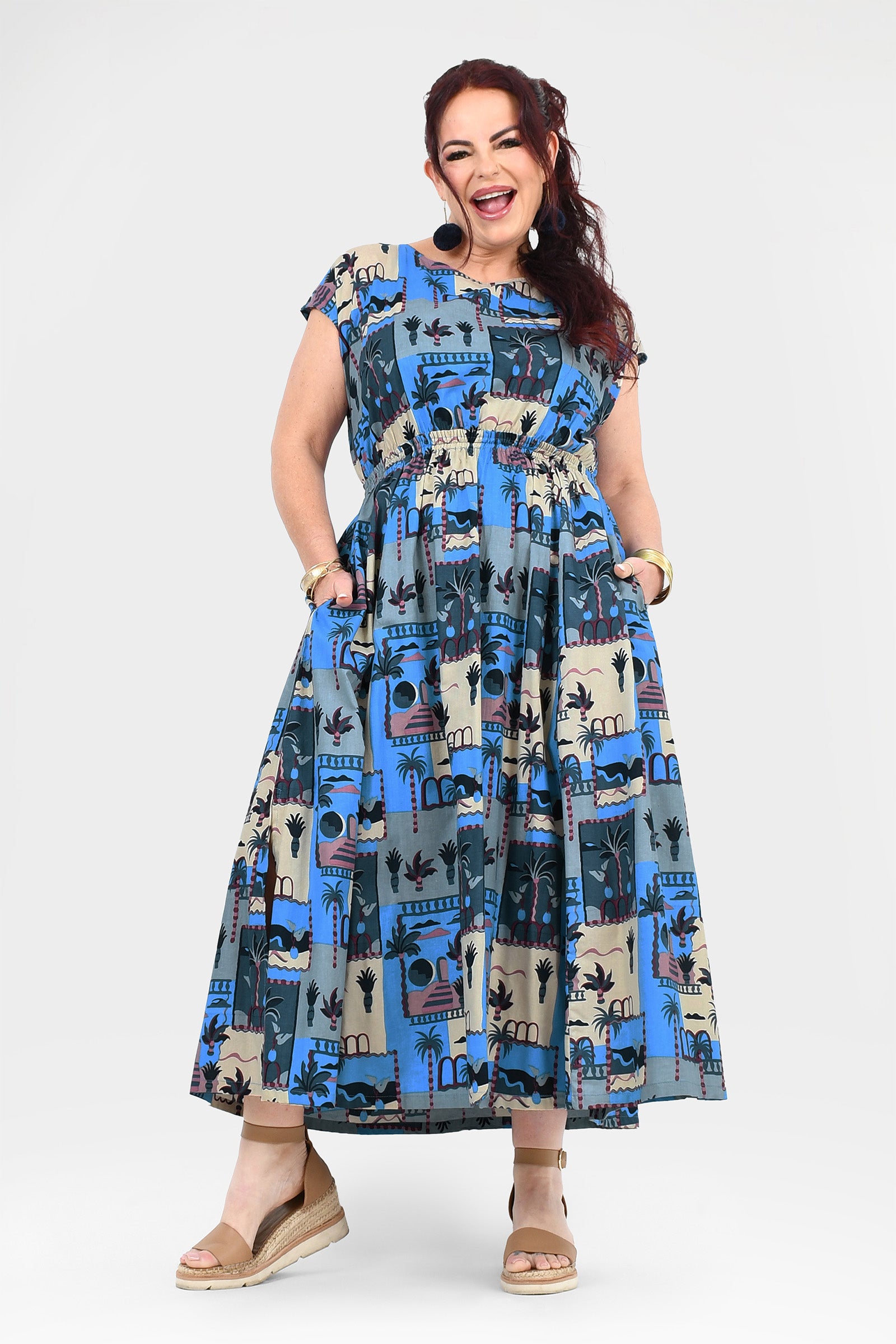 Blue-and-cream long dress with cap sleeves, gathered waist, and colorful illustrated print