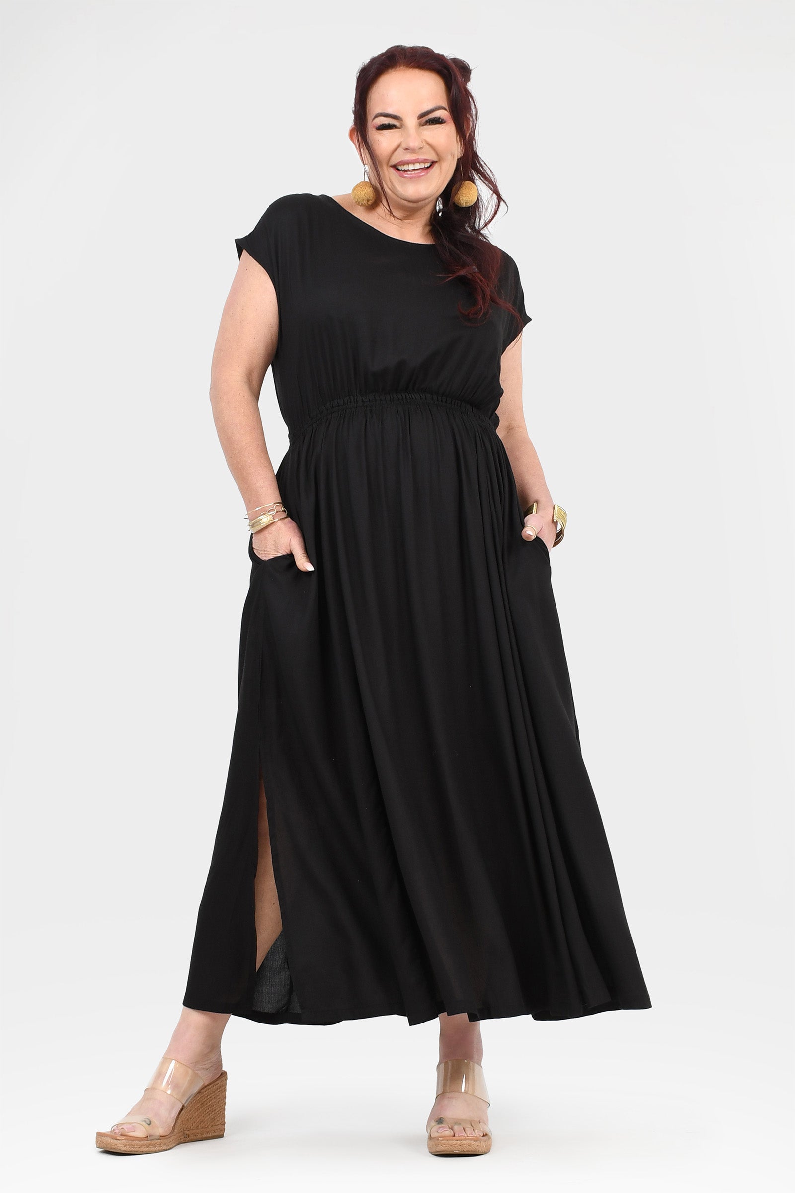 Black long dress with short sleeves, round neck, gathered waist, and side slit