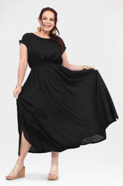 Black long dress with short sleeves, round neck, gathered waist, and flowing skirt
