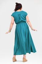 Back view teal long dress with short sleeves, elastic waist and flowing skirt