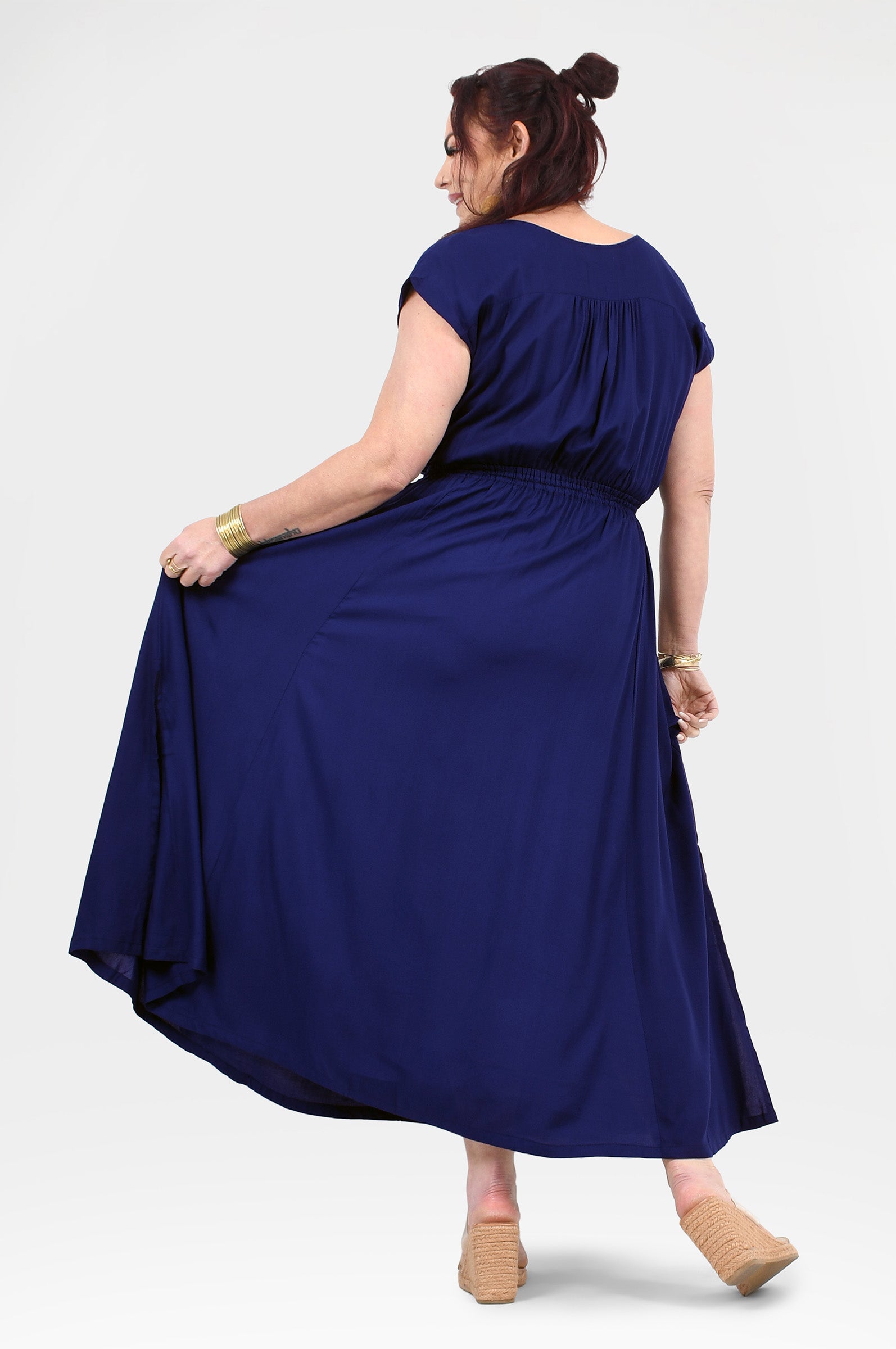 Dark blue long dress back view with gathered waist and flowing skirt