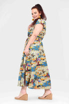 Colorful long dress with short sleeves, side view, city-and-jungle print, midi hem