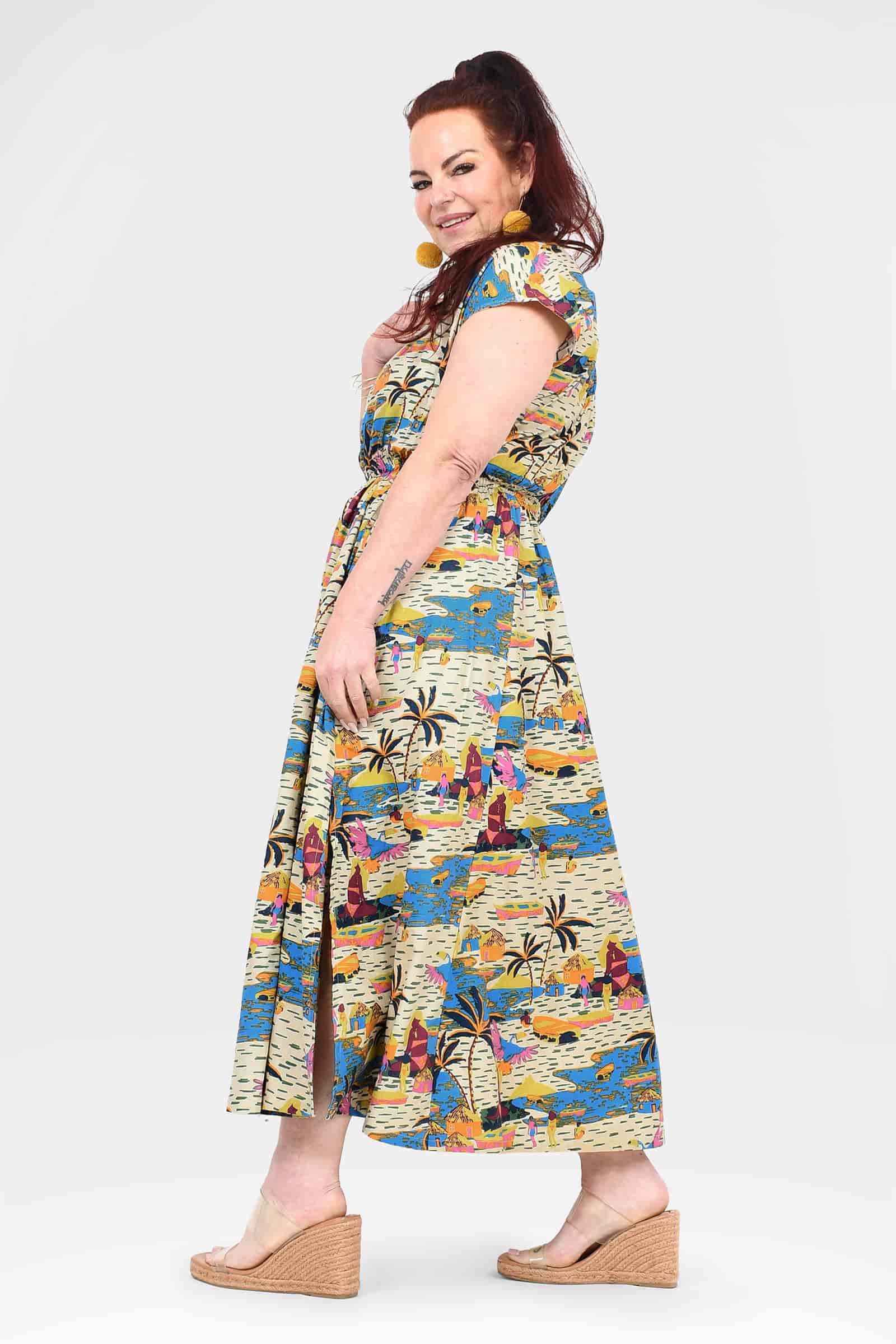 Colorful long dress with short sleeves, side view, city-and-jungle print, midi hem
