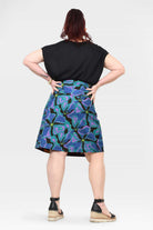 Back view of abstract teal, purple and blue skirt with black waistband detail