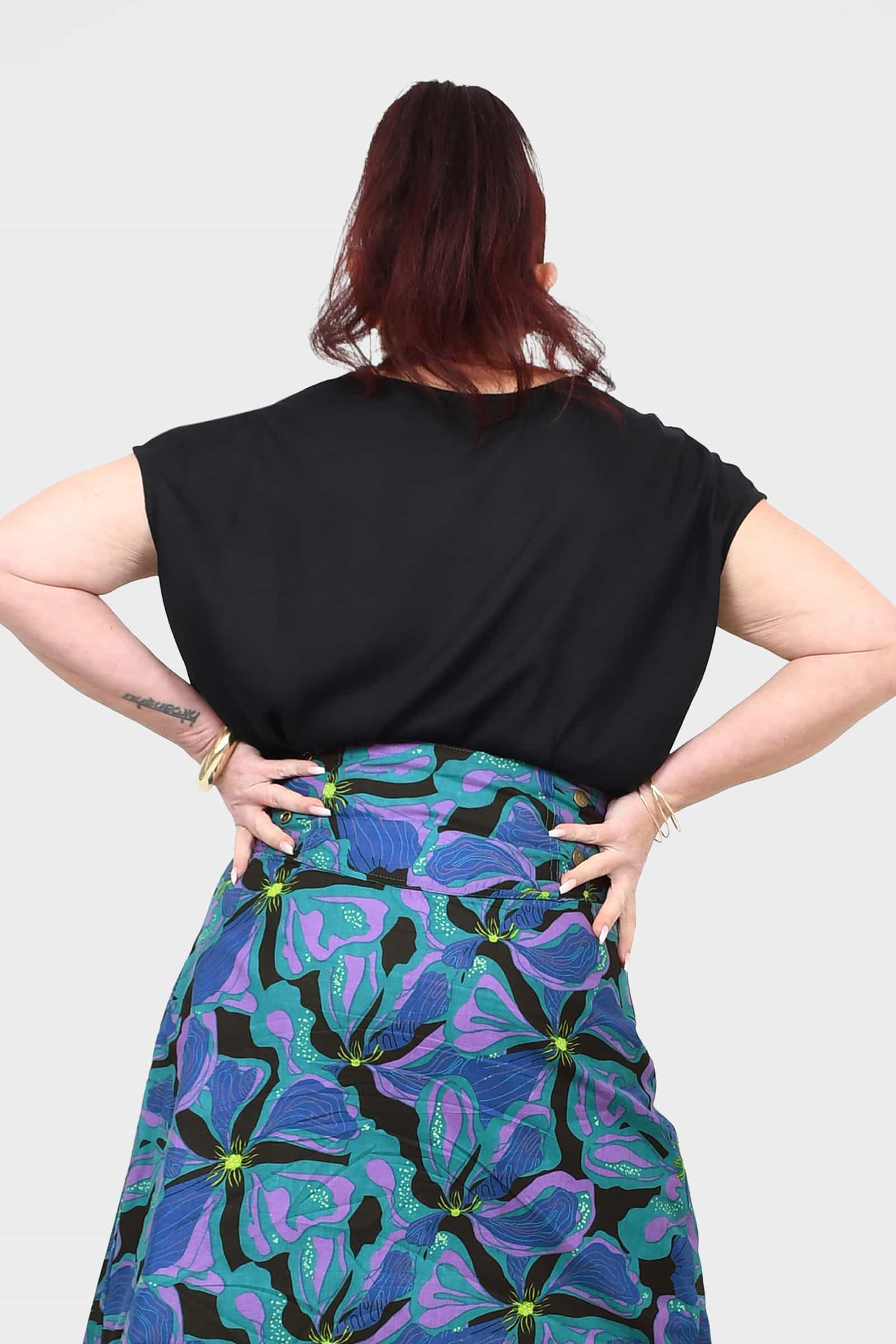 Black short-sleeve top with relaxed fit, crew neckline, open back view.