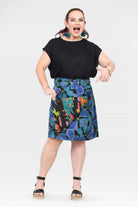 Front view of tropical print skirt on dark base with flared A-line hem