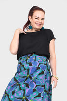 Black crew-neck short-sleeve top with draped shoulders and soft fall.
