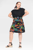 Front view of tropical print skirt on dark base with straight waistband