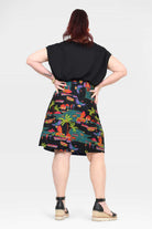 Back view of tropical print skirt on dark base with flared A-line hem