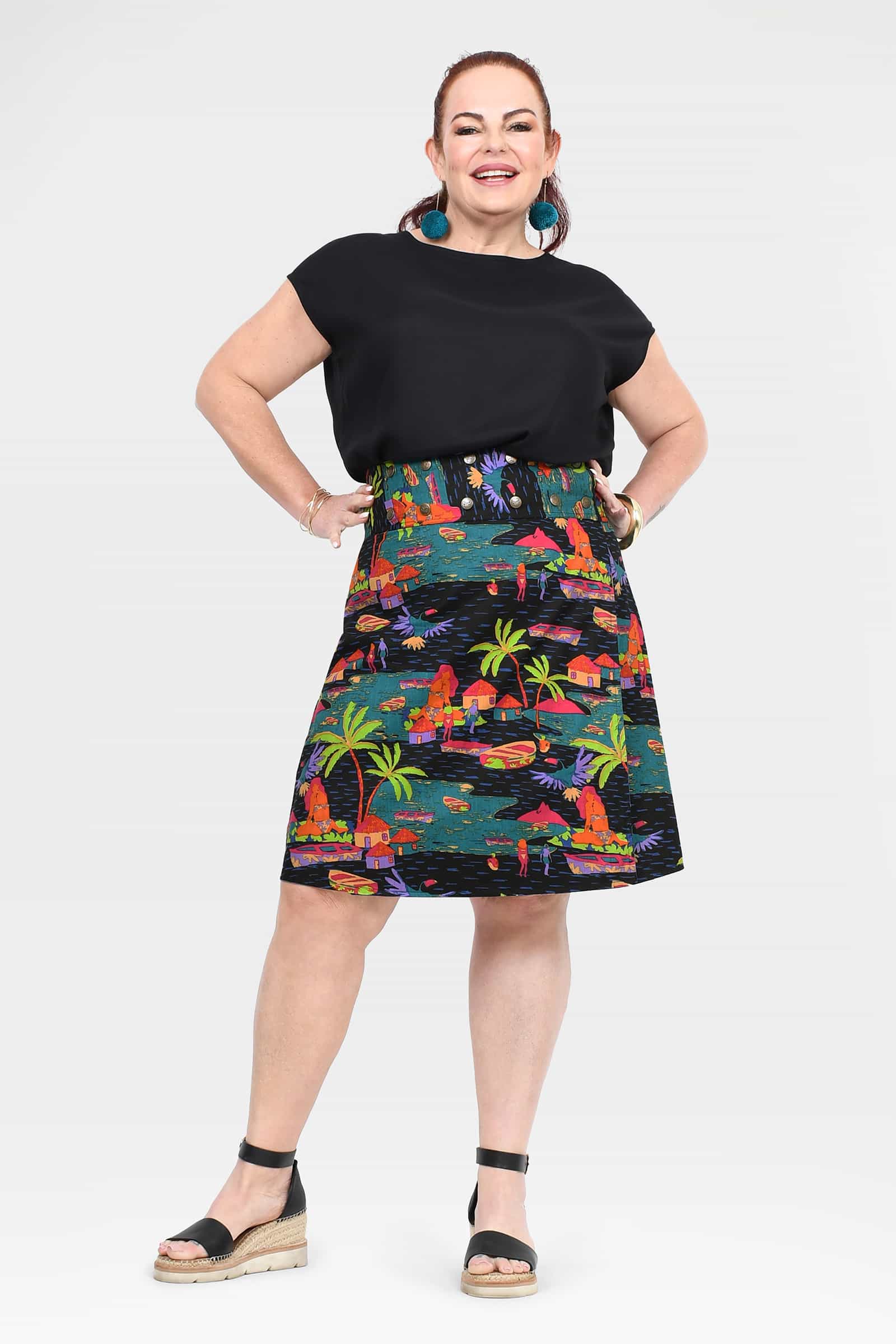 Reversible button skirt with colorful jungle print and dark trim, mid-calf length