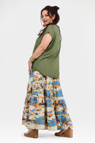 Flowy wide-leg pants with white base and blue-orange jungle print, elastic waistband