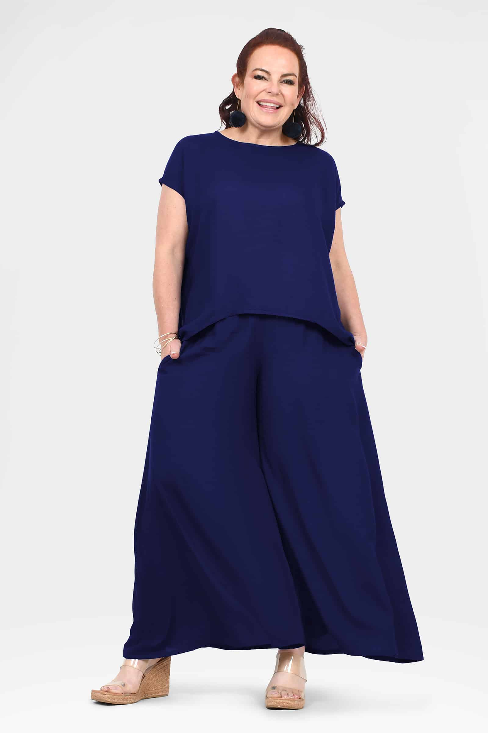 Dark navy wide-leg pants with loose drape and ankle-length hems