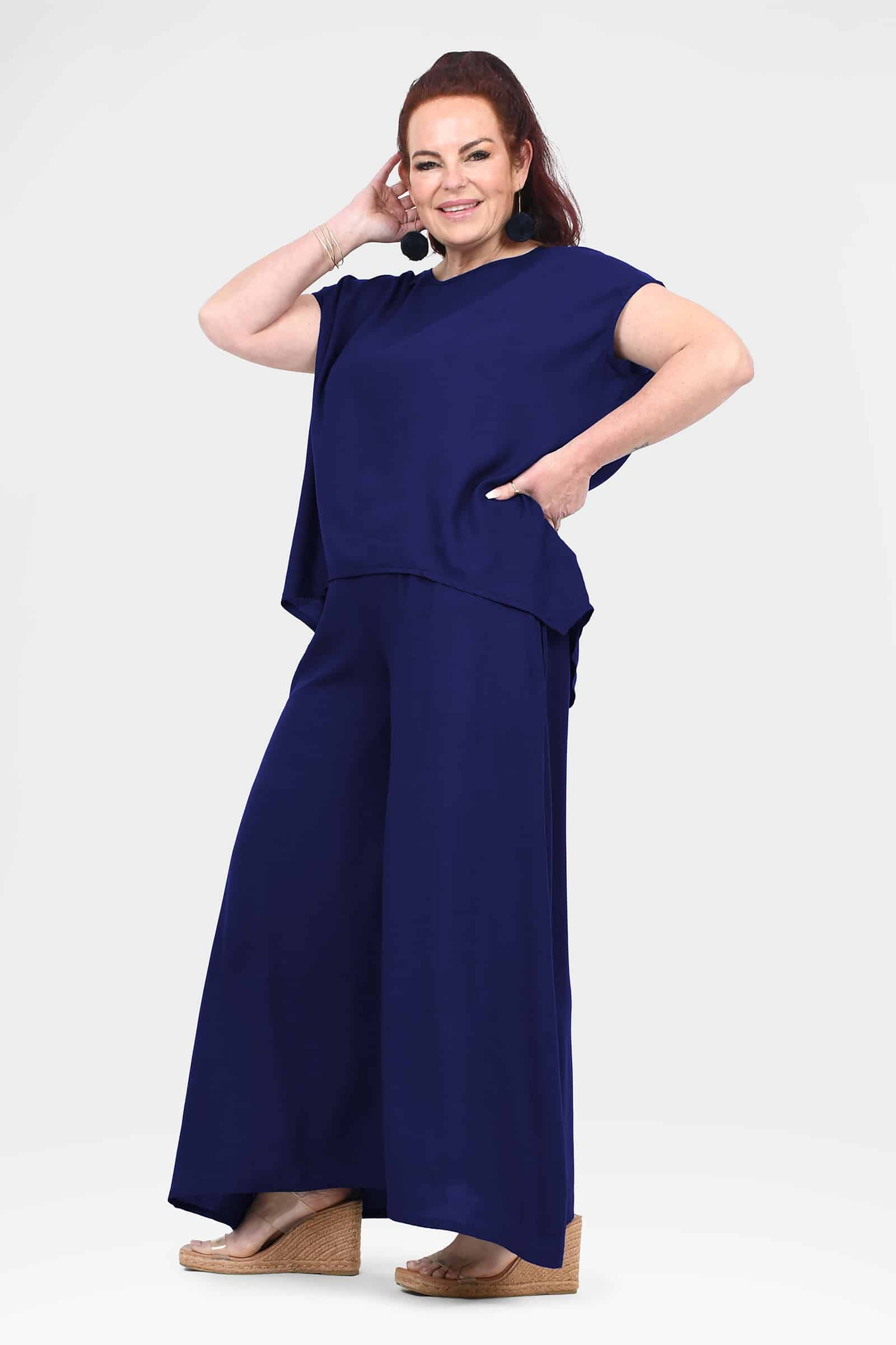 Dark navy wide-leg pants with flowing fabric and wide ankle-length legs