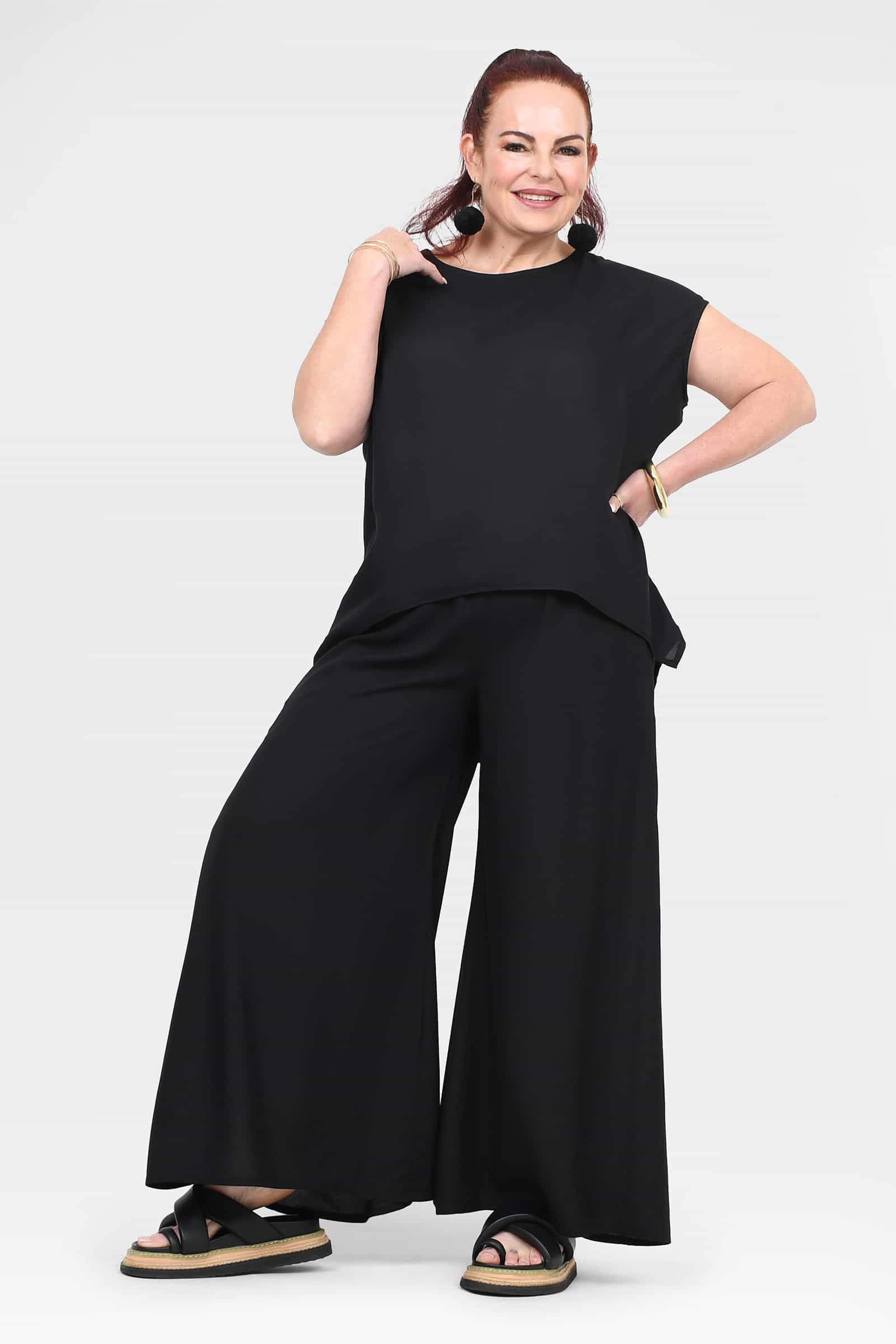 Black wide-leg pants with front drape; elastic waist and wide straight legs