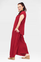 Dark red wide-leg pants, side view with relaxed fit and elastic waist