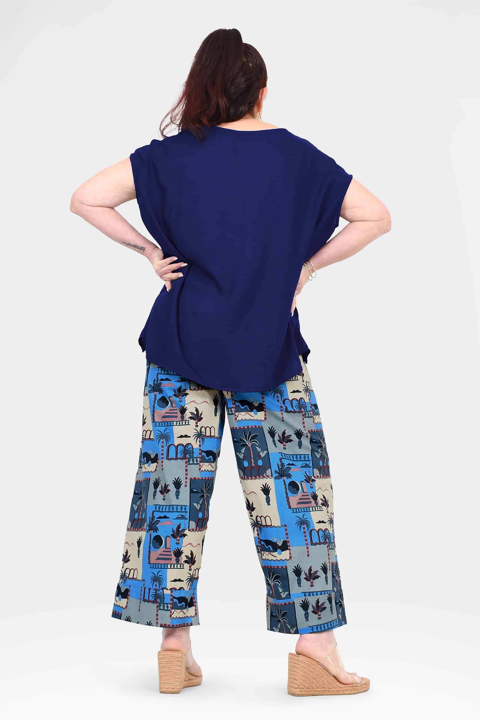Tully pants back view: wide-leg elastic waist with blue-and-cream landmark print