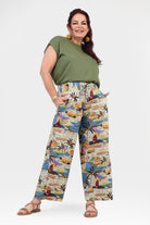 Printed wide-leg pants, off-white base with vibrant abstract jungle print