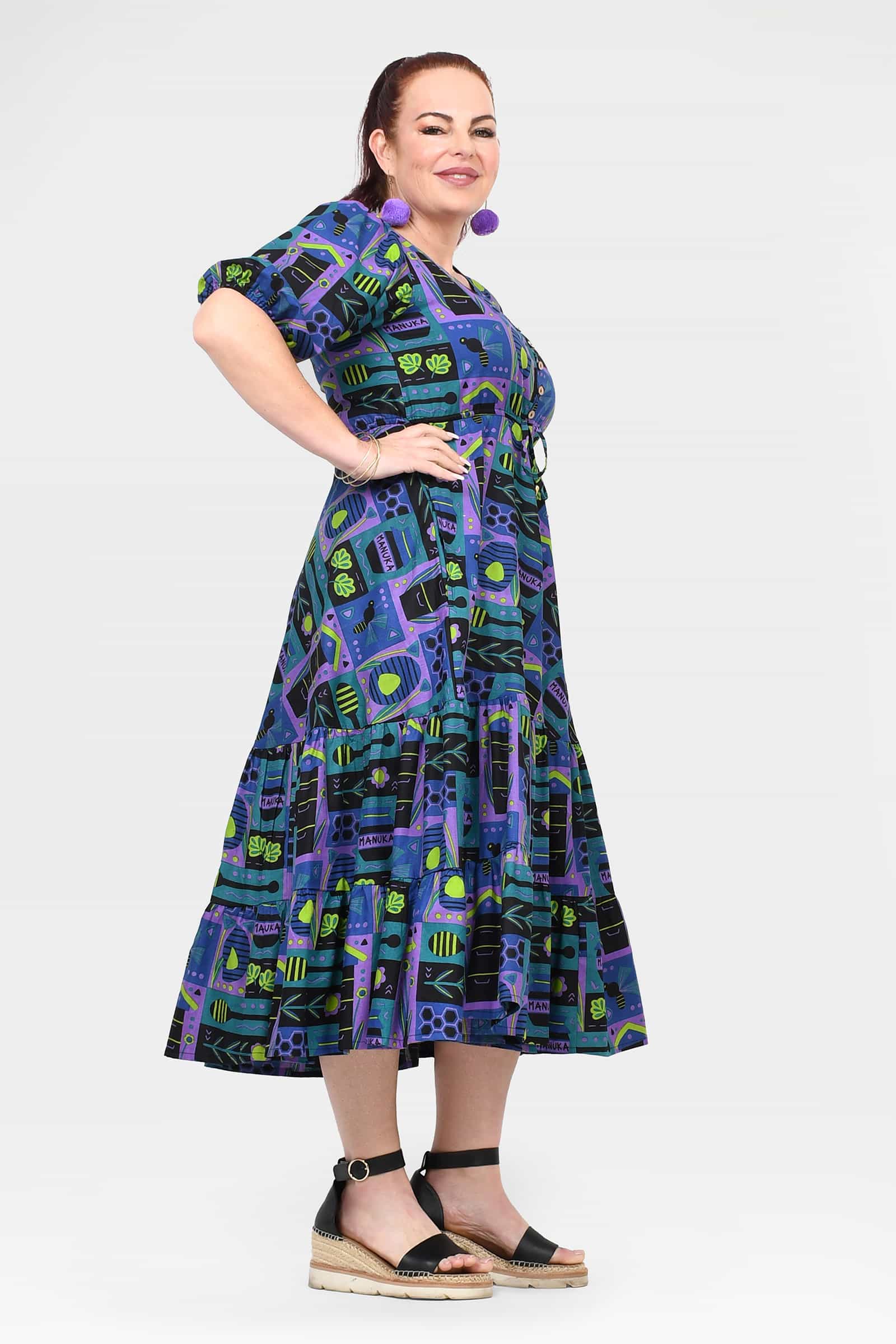 Ava midi dress on model, V-neckline and gathered waist in teal and purple print