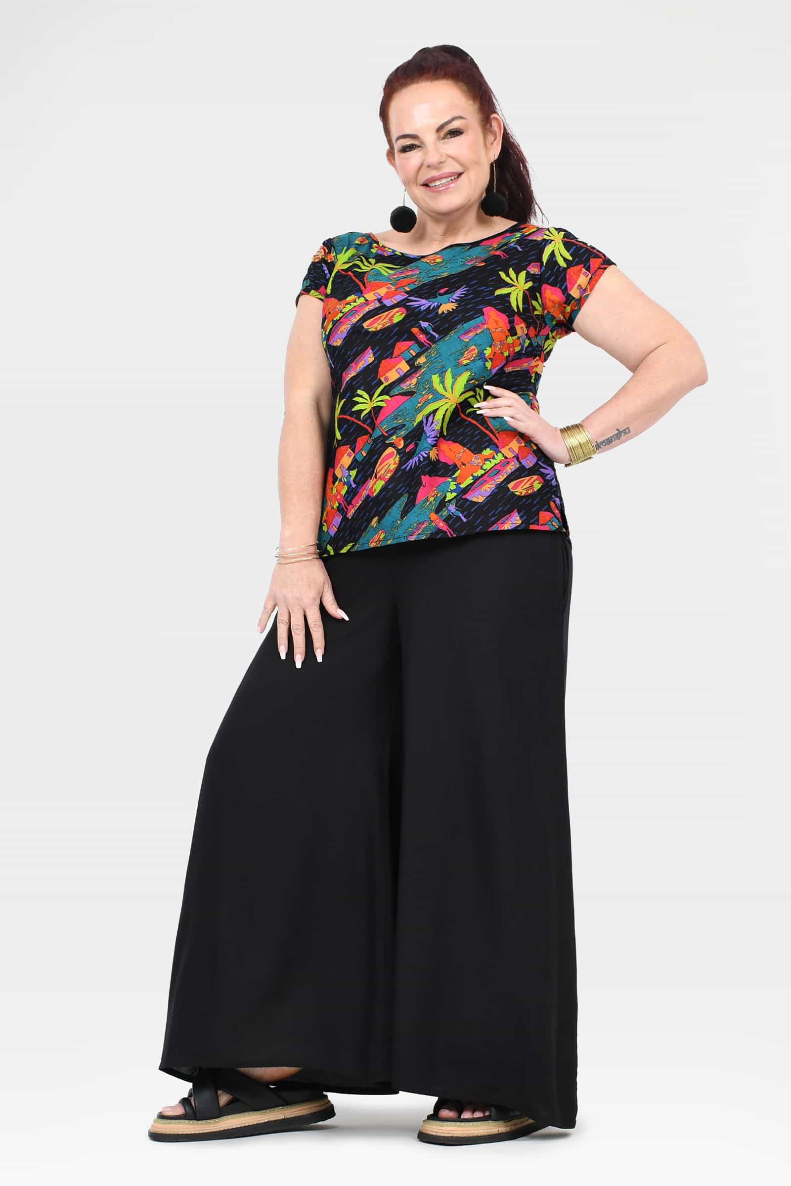 Black wide-leg pants with front stance; elastic waistband and wide flowing legs