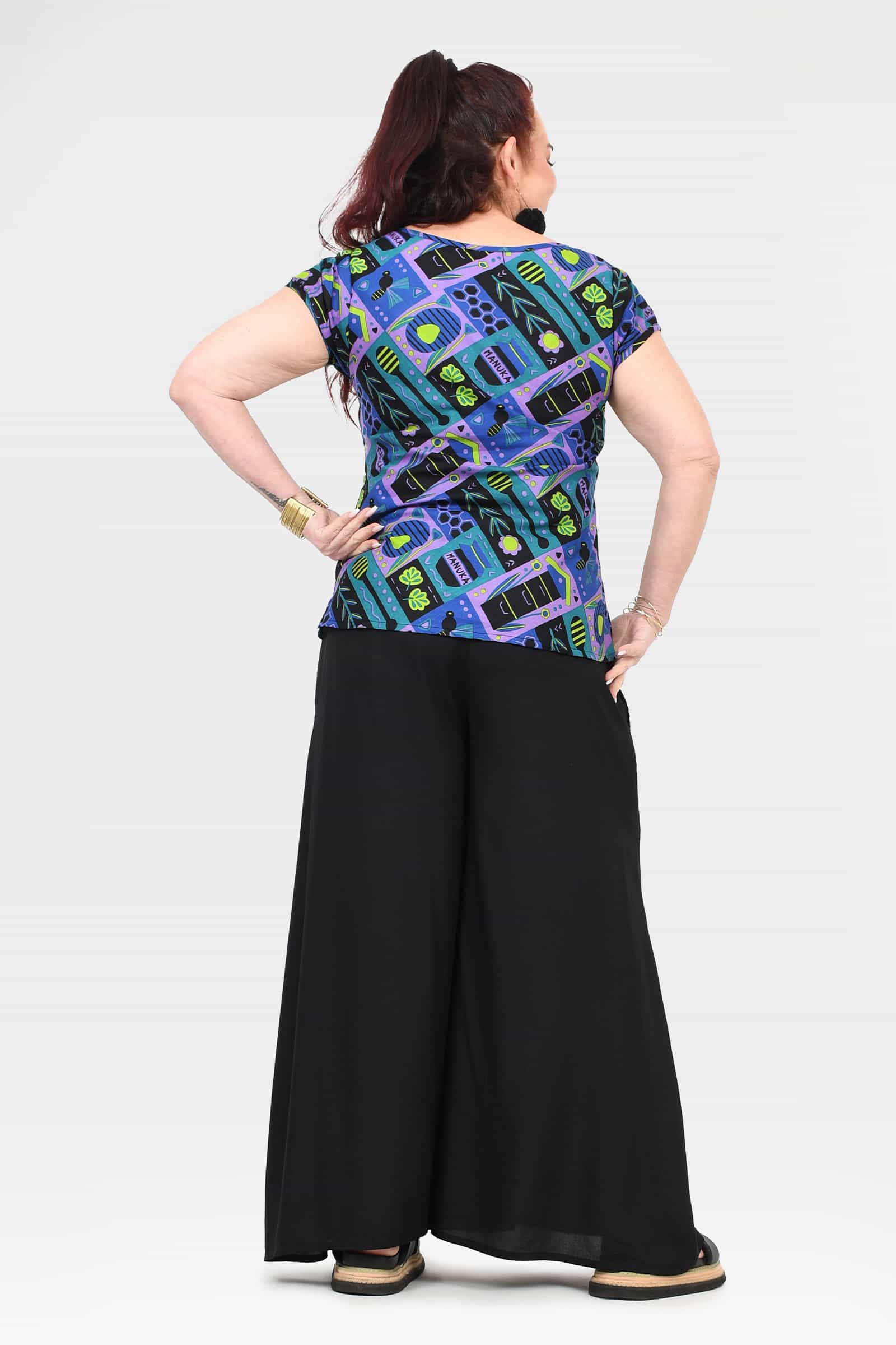 Black wide-leg pants with back view; elastic waist and wide floor-grazing hem